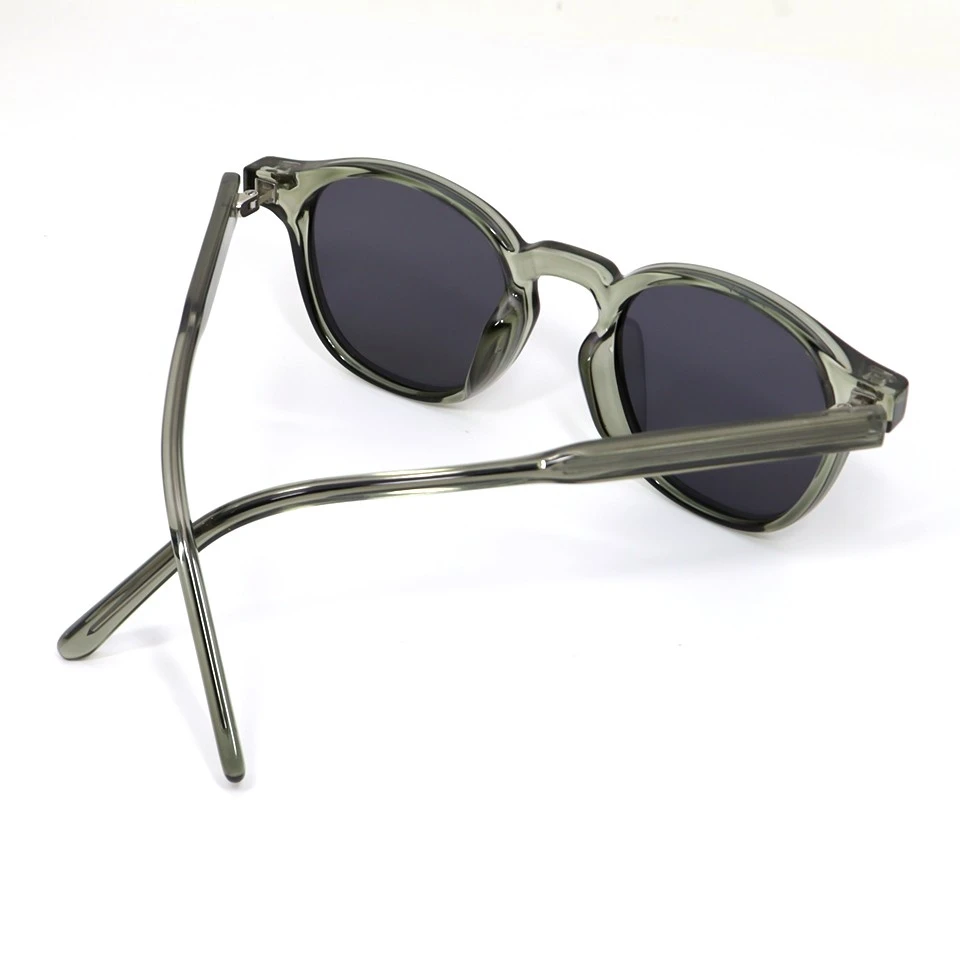 Side view of round translucent acetate sunglasses showing temple curve and olive green frame Side view of round translucent acetate sunglasses showing temple curve and olive green frame